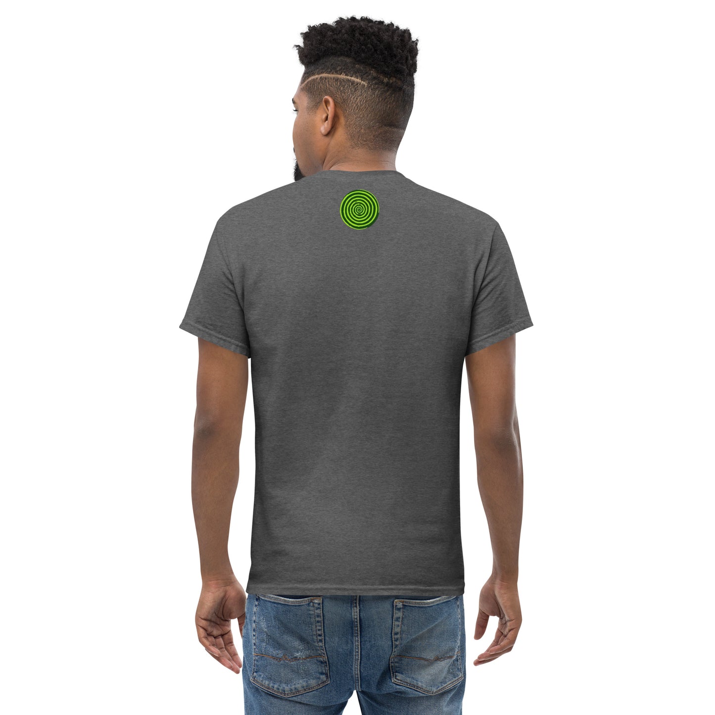 Person wearing a dark gray t-shirt with a green circular design on the back, standing against a white background.